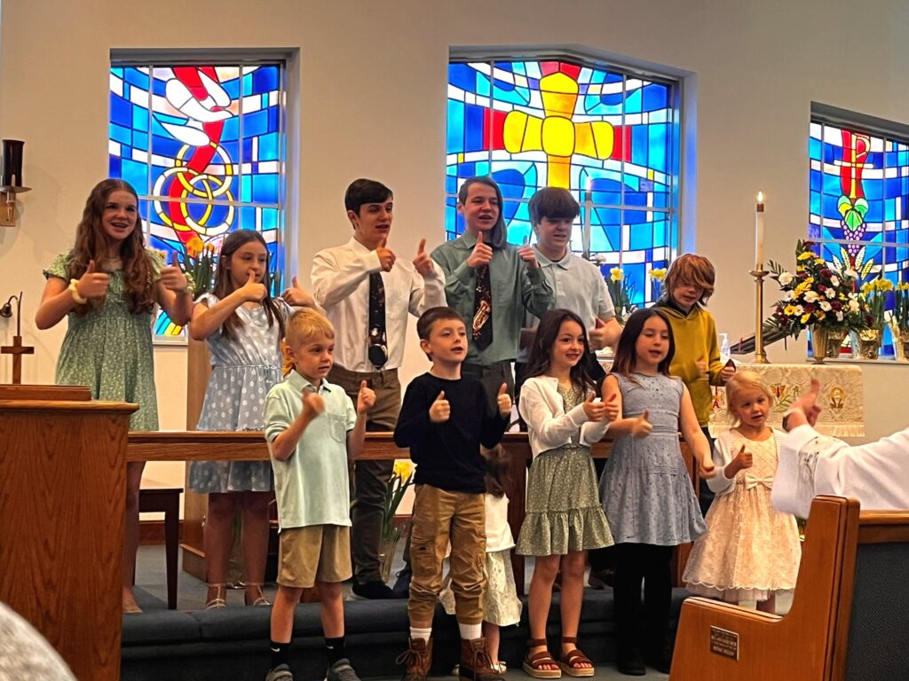 A photo of children in the youth choir singing for the church